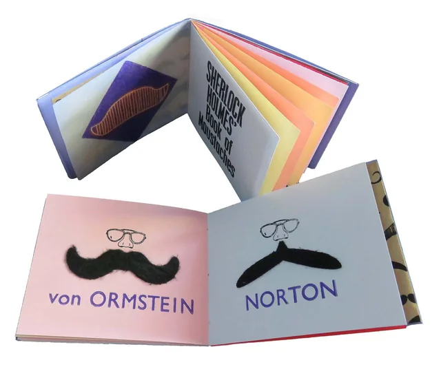 Sherlock Holmes’ Book of Moustaches open at two pages, “von Ormstein” and “Norton”, each with a stick-on moustache.